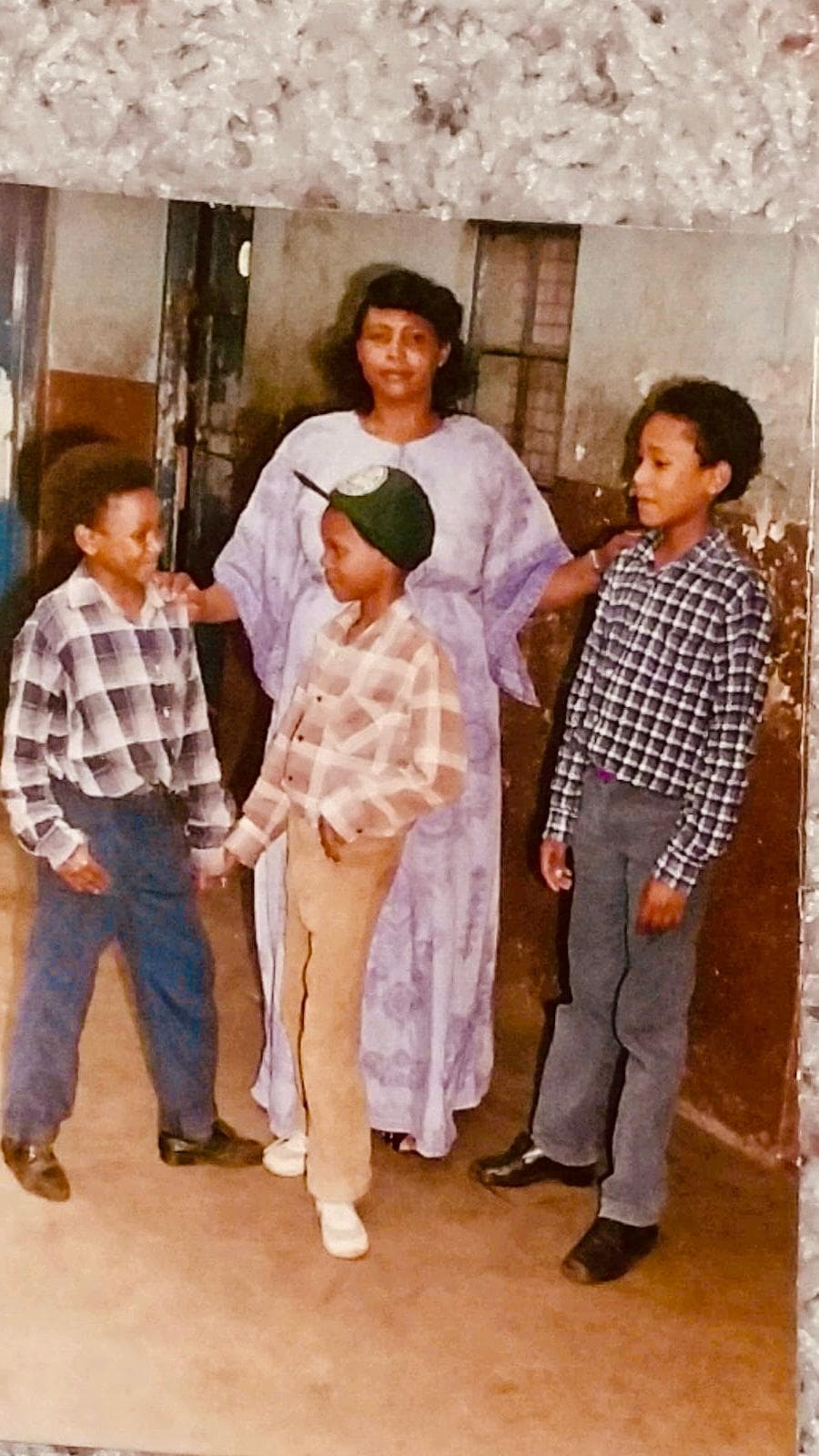 Jonas Muthoni as a child with his mother and brothers